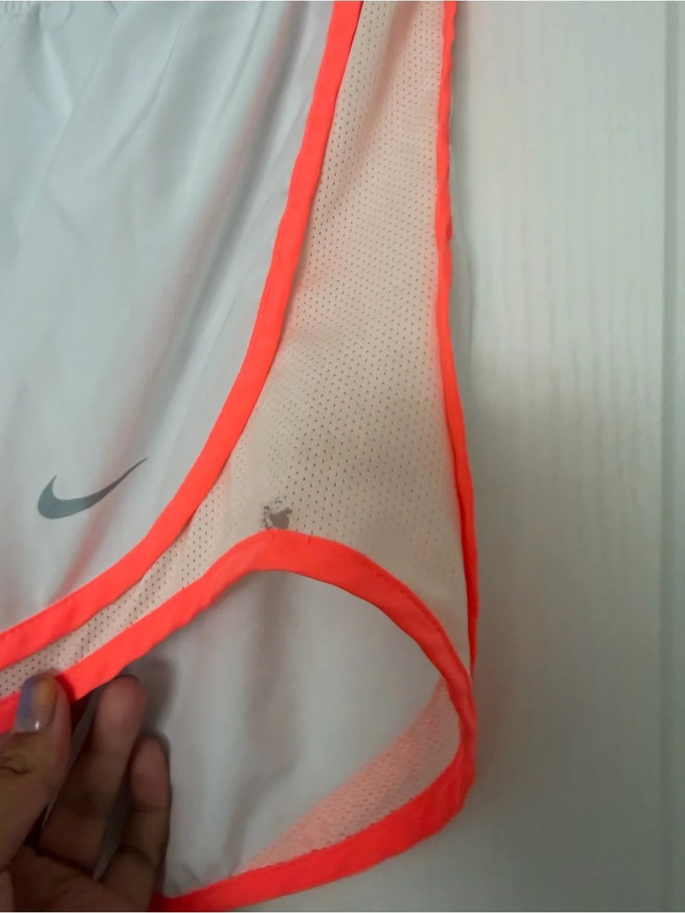 Nike Dri-Fit white running shorts with orange trim, size M